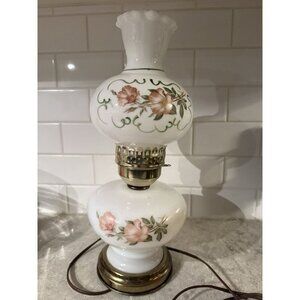Vintage Milk glass electric hurricane lamp with brass base and floral motifs.